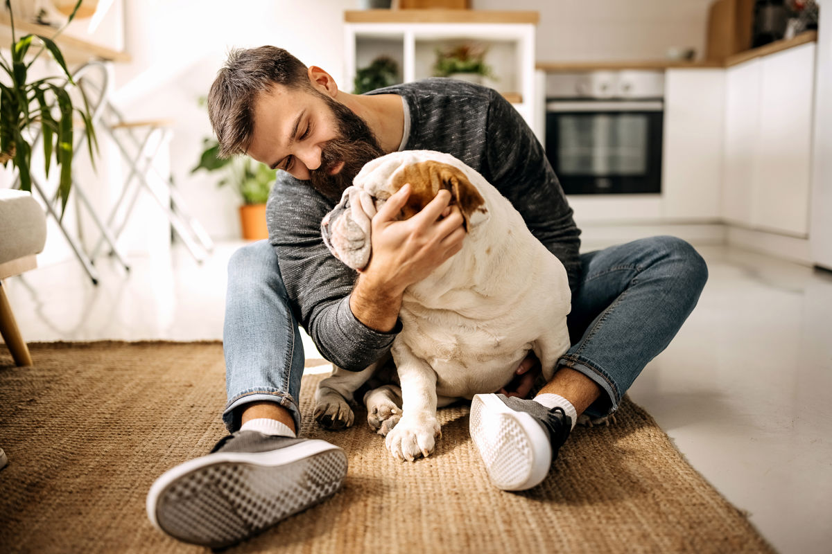 Man sitting on the floor with a dog.jpg
